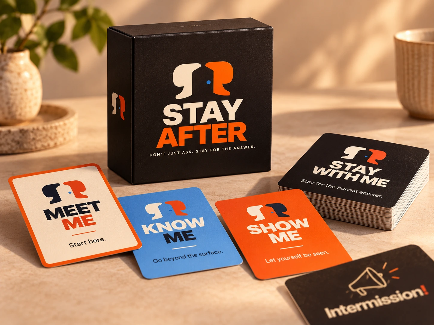 Stay After black box with its official cream and orange logo, alongside the cream Meet Me, blue Know Me, orange Show Me, black Stay With Me and Intermission cards on a warm tabletop